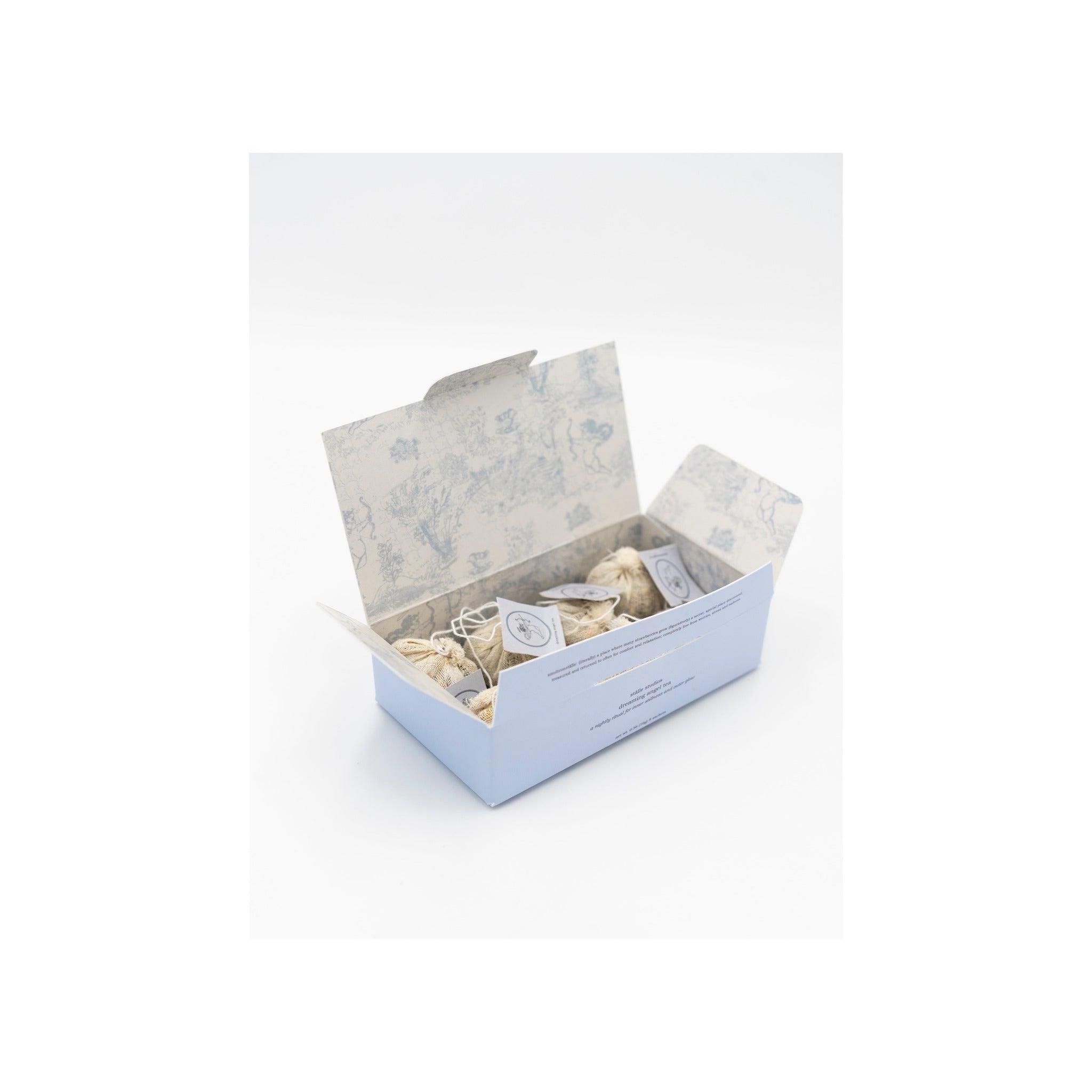 Dreaming Angel Tea open gift box with toile-print interior and muslin tea sachets inside