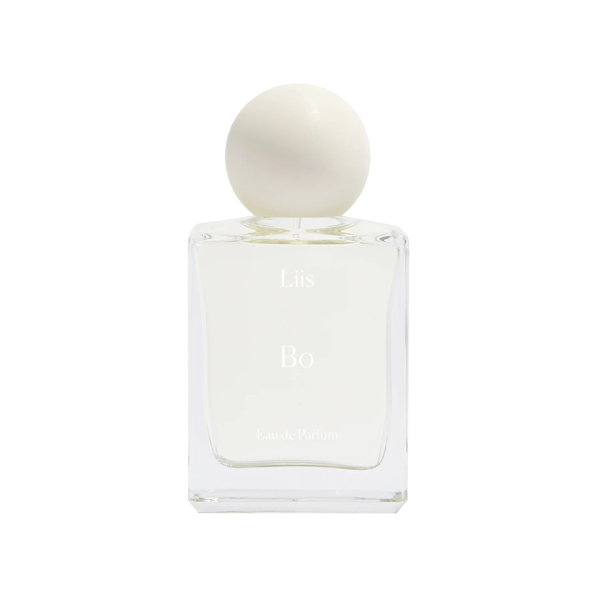Liis Bo Eau de Parfum in a clear glass bottle with a rounded cream ceramic cap