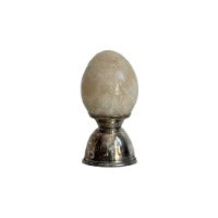 Marble egg on a small silver holder stand