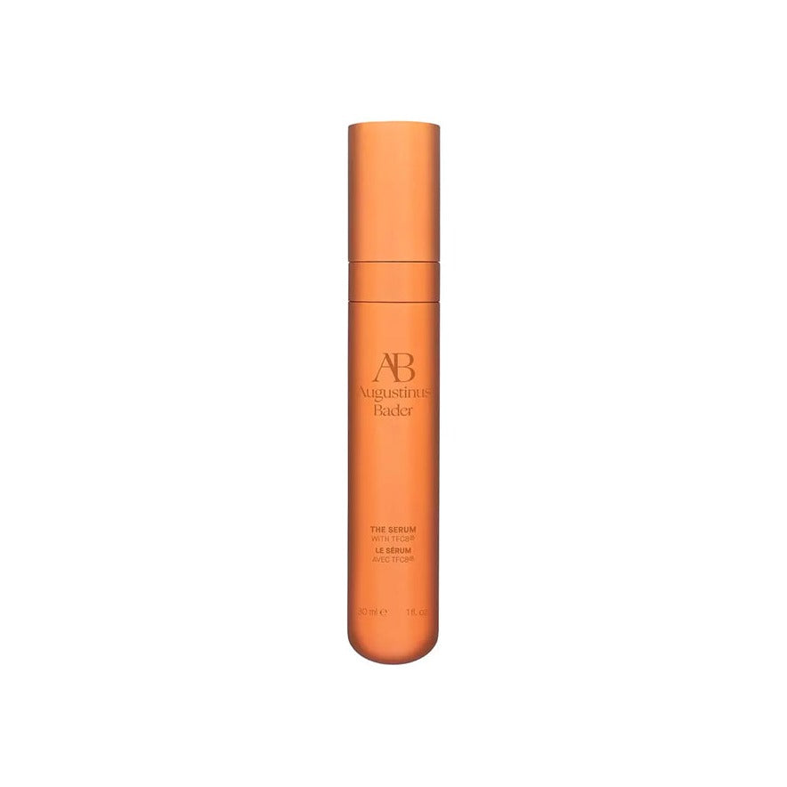 Augustinus Bader The Serum in a tall orange pump bottle with AB logo