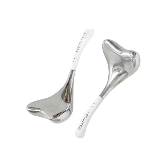 Beautology Cryo Toning Tools — pair of silver metal facial massage spoons with white branded handles