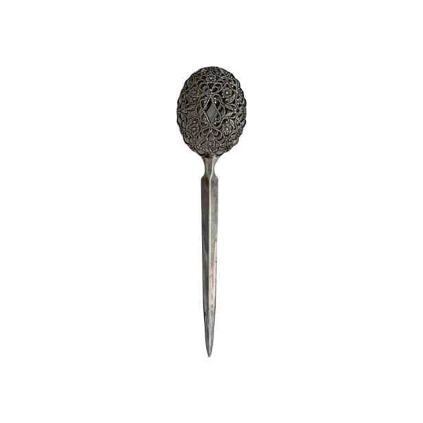 Silver envelope opener with ornate oval filigree handle and pointed blade