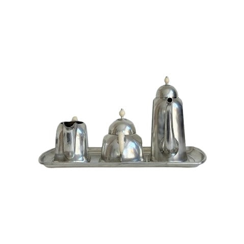 Pewter trio set on tray including pitcher, sugar bowl, and milk can with ivory finials