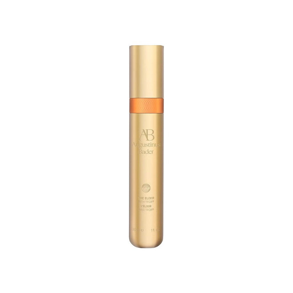 Augustinus Bader The Elixir in a sleek gold bottle with orange leather accent band