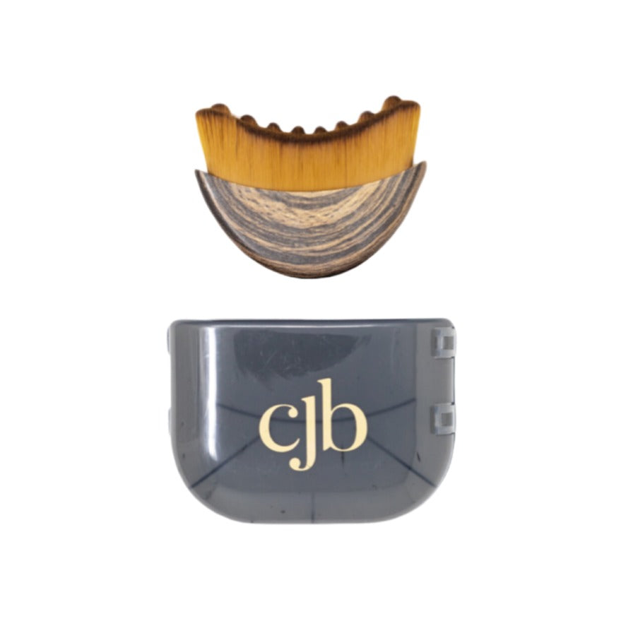 CJB Lymphatic Brush Face with scalloped golden bristles and wood handle, shown with grey travel case